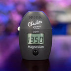 Hanna Checker HC HI783 marine magnesium in front of a reef aquarium