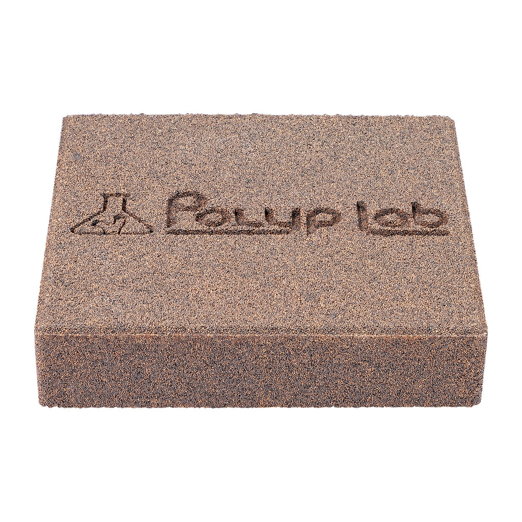 Polyplab Genesis Rock, single rock in three-quarter view with engraved Polyp Lab logo and grainy surface